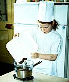 Caoimhe Cashman Putting the broken-up chocolate in a bowl that is over a saucepan of water